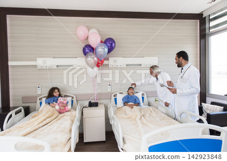 Middle Eastern eye hospital pediatric ward with doctors examining child patients in modern clinic in Egypt Middle Eastern eye hospital pediatric ward with doctors examining child patients in modern clinic in Egypt 142923848