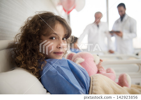 Young girl patient in a Middle Eastern eye hospital bed with doctors consulting in an Egyptian clinic Young girl patient in a Middle Eastern eye hospital bed with doctors consulting in an Egyptian clinic 142923856