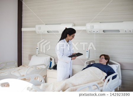 Female doctor consulting with patient in a modern Middle Eastern eye hospital clinic in Egypt Female doctor consulting with patient in a modern Middle Eastern eye hospital clinic in Egypt 142923890