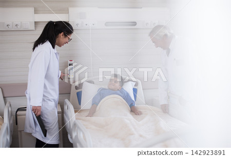 Doctors consult with a young patient in a modern Middle Eastern eye hospital clinic in Egypt Doctors consult with a young patient in a modern Middle Eastern eye hospital clinic in Egypt 142923891