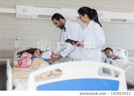 Doctors and nurses caring for pediatric patients in a modern Middle Eastern eye hospital clinic in Egypt 142923913