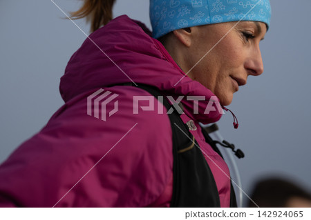 Determined Woman Hiker In Pink Jacket And Blue Beanie Outdoors On A Cold Morning Hike 142924065