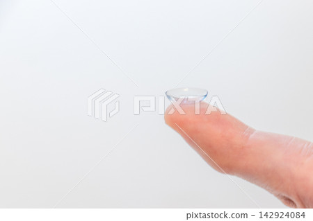 Contact lens placed on fingertip Contact lens placed on fingertip 142924084