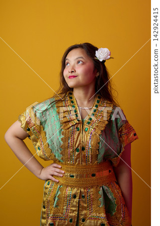 Young Indonesian Asian Woman in Gold Embroidered Traditional Dress With White Flower in Hair Portrait Young Indonesian Asian Woman in Gold Embroidered Traditional Dress With White Flower in Hair Portrait 142924415