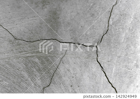 Monochromatic cracked concrete surface background Monochromatic cracked concrete surface background 142924949