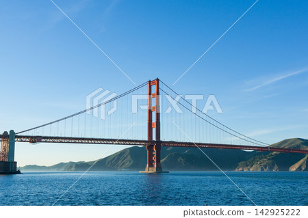 A full frontal view of the Golden Gate Bridge against the blue sky of San Francisco Bay. A full frontal view of the Golden Gate Bridge against the blue sky of San Francisco Bay. 142925222