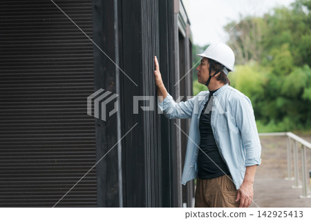 Site supervisor inspecting a used house Site supervisor inspecting a used house 142925413