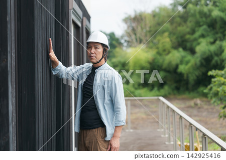 Site supervisor inspecting a used house Site supervisor inspecting a used house 142925416