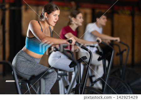 Woman in the top is engaged in an airbike Woman in the top is engaged in an airbike 142925429