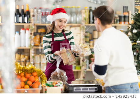 Woman seller offering turrons and nougat Woman seller offering turrons and nougat 142925435