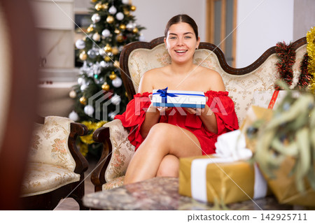 prepearing for New Year and preparing surprises, girl picked up most beautiful gift prepearing for New Year and preparing surprises, girl picked up most beautiful gift 142925711