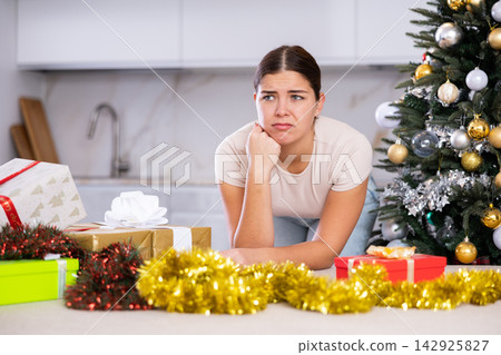 upset girl in a festive New Year s atmosphere upset girl in a festive New Year s atmosphere 142925827