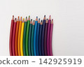 Colored Pencils Arranged in a Row on White Background 142925919