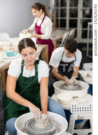 Woman working with pottery wheel Woman working with pottery wheel 142926148
