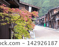 Old houses and maple trees shrouded in rain. 142926187