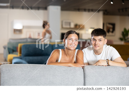 Couple man and woman choosing sofa in store 142926193