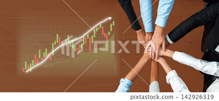 Team Collaboration to Achieve Business Growth with Graph Analysis and Hands Joining Together on a Wooden Table Background Axiom Team Collaboration to Achieve Business Growth with Graph Analysis and Hands Joining Together on a Wooden Table Background Axiom 142926319