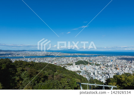 Views of Tokushima city and the blue sea of the Yoshino River estuary and Kii Channel from Mount Bizan Views of Tokushima city and the blue sea of the Yoshino River estuary and Kii Channel from Mount Bizan 142926534