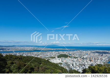 A clear, panoramic view of Tokushima city and the Kii Channel from the summit of Mount Bizan. A clear, panoramic view of Tokushima city and the Kii Channel from the summit of Mount Bizan. 142926536