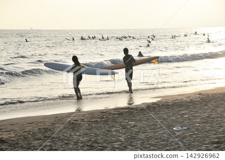 People surfing at Kugenuma Beach in the evening. People surfing at Kugenuma Beach in the evening. 142926962