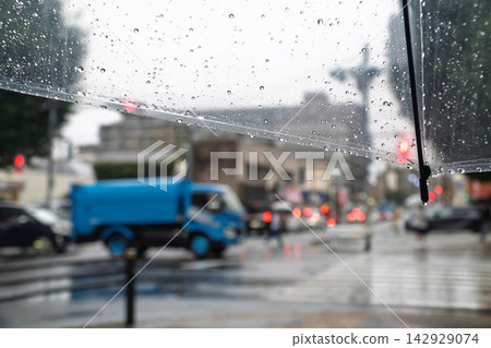雨天，人們撐著傘走在人行道上。 142929074