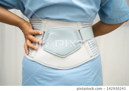 Asian senior pain back wearing elastic support belt with walker. Asian senior pain back wearing elastic support belt with walker. 142930241