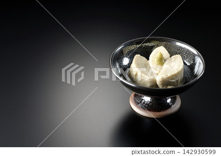 Fresh yuba (tofu skin) photographed against a black background. Fresh yuba (tofu skin) photographed against a black background. 142930599