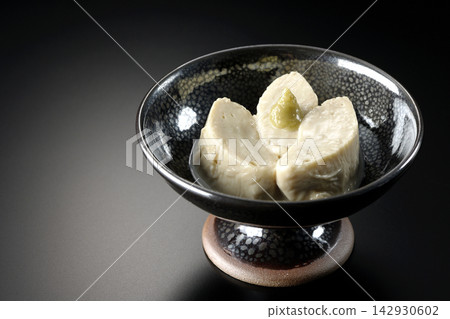 Fresh yuba (tofu skin) photographed against a black background. Fresh yuba (tofu skin) photographed against a black background. 142930602