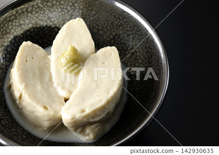 Fresh yuba (tofu skin) photographed against a black background. Fresh yuba (tofu skin) photographed against a black background. 142930635