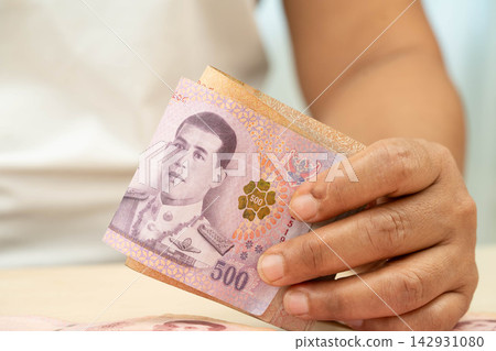 Asian woman counting Thai baht banknote money, investment economy, accounting business and banking. Asian woman counting Thai baht banknote money, investment economy, accounting business and banking. 142931080