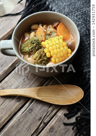 A wool blanket and a vegetable-rich soup with soy milk and tomatoes. A wool blanket and a vegetable-rich soup with soy milk and tomatoes. 142931759