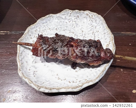 Grilled chicken cheek skewers with green onions - a Japanese-style dish Grilled chicken cheek skewers with green onions - a Japanese-style dish 142932261