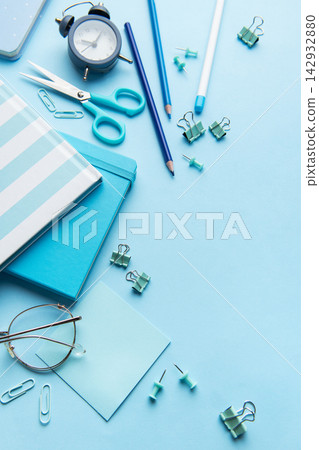 Blue stationery, notebooks, and office supplies organized on a desk Blue stationery, notebooks, and office supplies organized on a desk 142932880