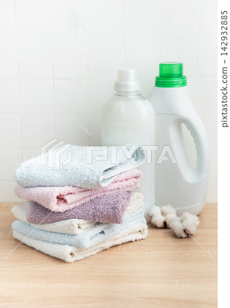 Stack of soft clean towels with laundry detergents Stack of soft clean towels with laundry detergents 142932885