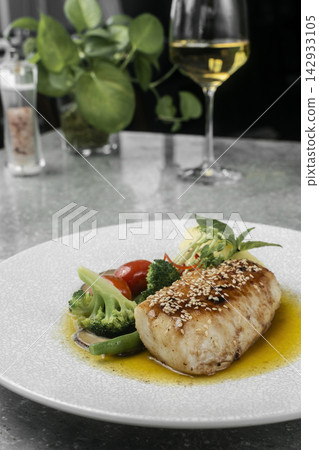 asian style fusion cod fillet with vegetables and sweet sesame ginger sauce on restaurant table asian style fusion cod fillet with vegetables and sweet sesame ginger sauce on restaurant table 142933105