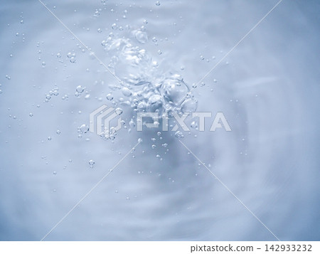 Bubbles rising in the water, against a blue abstract background. Bubbles rising in the water, against a blue abstract background. 142933232