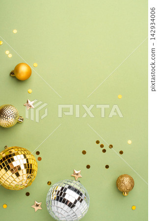 Christmas gold ornaments on a green background. 142934006
