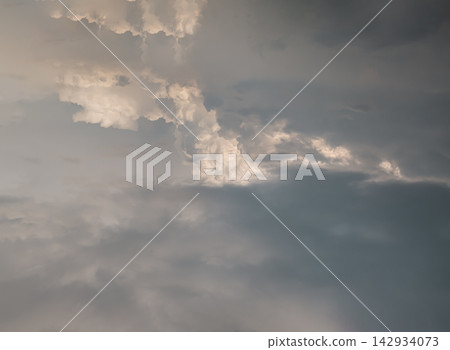 Ethereal cloud formation resembling the geographical shape of Italy against a moody sky. A unique cumulus cloud sculpted into a country map outline. Golden hour light illuminating a unique, map-shaped Ethereal cloud formation resembling the geographical shape of Italy against a moody sky. A unique cumulus cloud sculpted into a country map outline. Golden hour light illuminating a unique, map-shaped 142934073