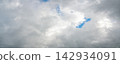 Panoramic view of dramatic gray storm clouds with patches of blue sky 142934091