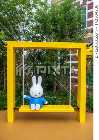 Miffy figure on yellow swing at Wonder Square, Huis Ten Bosch, Nagasaki Miffy figure on yellow swing at Wonder Square, Huis Ten Bosch, Nagasaki 142934236
