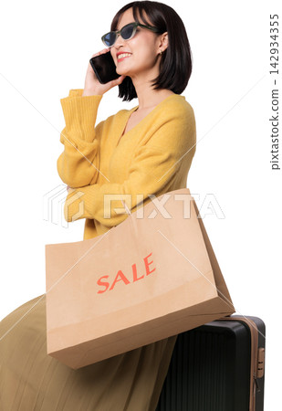 Happy asian woman talking phone holding paper bag discussing artificial intelligence chatbot shopping assistant with joyful emotional expression near luggage on transparency background 142934355