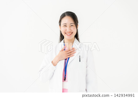 Woman in a white coat, scrubs Woman in a white coat, scrubs 142934991