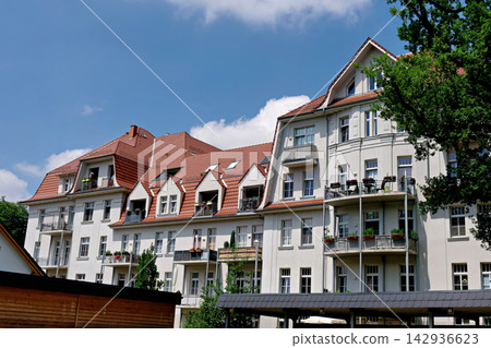 Large residential apartment complex with white walls and red tiled roofs Large residential apartment complex with white walls and red tiled roofs 142936623