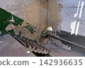 High angle view of a broken concrete staircase in an abandoned building with peeling walls 142936635