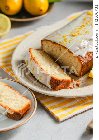 Homemade lemon loaf cake with citrus glaze, lifestyle food background Homemade lemon loaf cake with citrus glaze, lifestyle food background 142936731