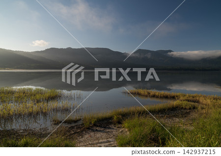 Lake Usori in the morning and the grass on its shore (Mount Osore) Lake Usori in the morning and the grass on its shore (Mount Osore) 142937215
