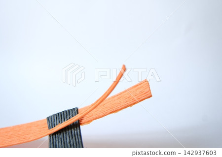 The process of tearing craft band with force - hands The process of tearing craft band with force - hands 142937603