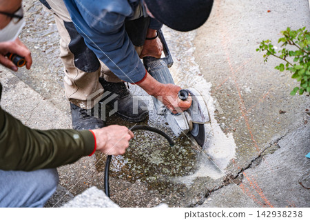 Construction work on a concrete surface in a residential area during daytime 142938238