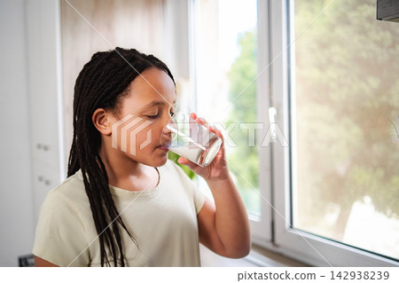 Young girl drinking milk for healthy growth and nutrition Young girl drinking milk for healthy growth and nutrition 142938239