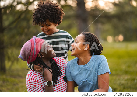 African American family spending time together in park African American family spending time together in park 142938263